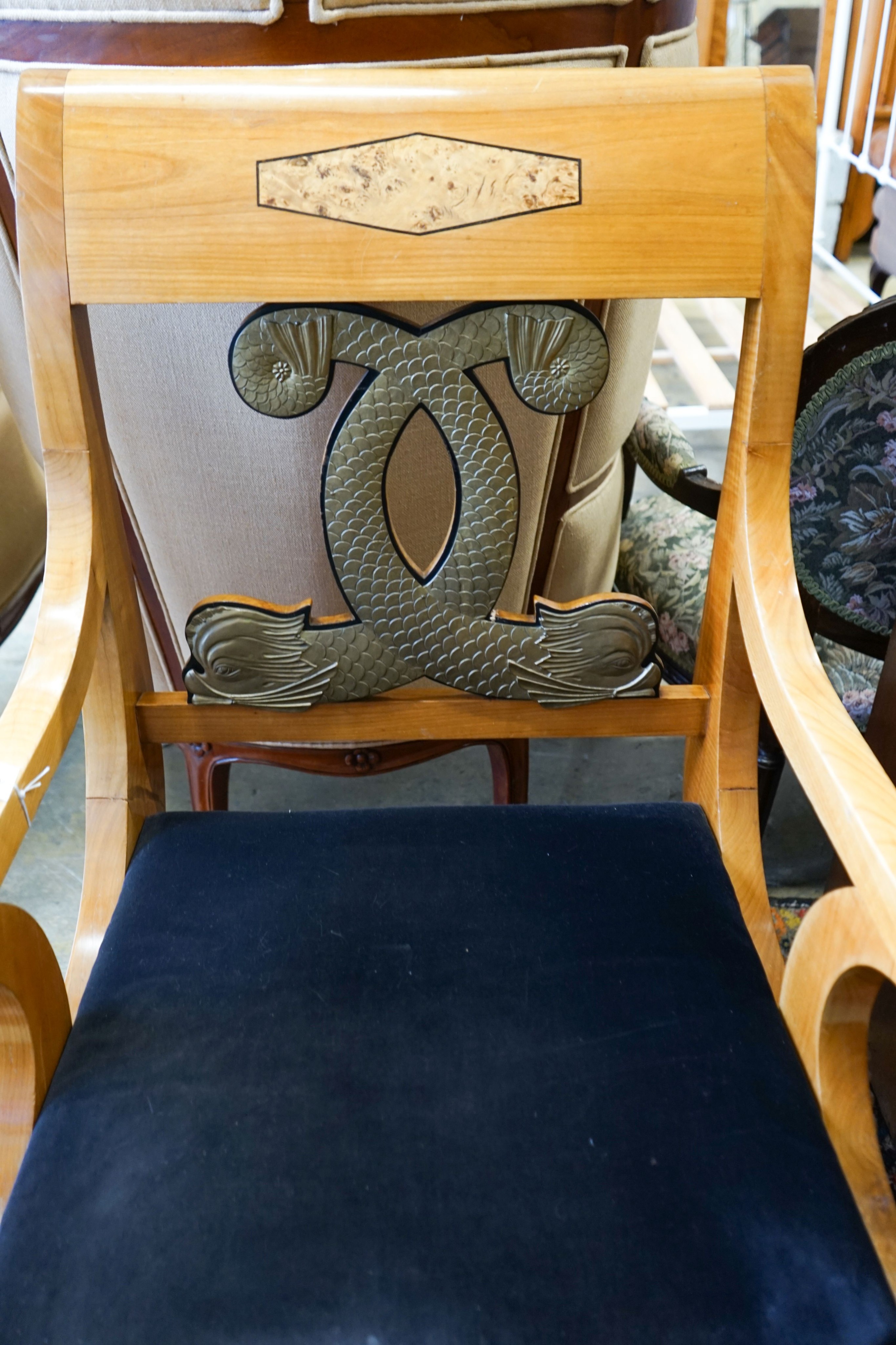 A pair of Empire style cherry elbow chairs with gilt metal dolphin mounts, width 65cm, depth 56cm, height 107cm